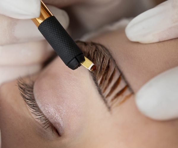 beautician-doing-microblading-procedure-client-s-eyebrows